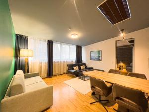 uma sala de estar com uma grande mesa de madeira e cadeiras em Exklusives Leipzig City Apartment Aurora em Leipzig