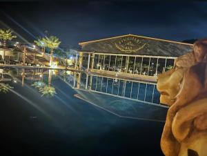 a building with a swimming pool at night at Paradice Hotel Luxury Suites-Near zorbas Beach-FREE Breakfast in Stavros