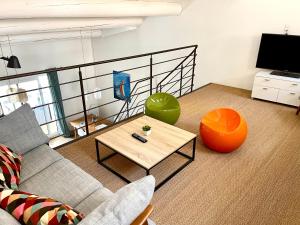 a living room with a couch and a coffee table at La Maison du Courtil, Amande-Olive in Moustiers-Sainte-Marie