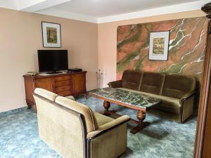 a living room with a couch and a table at Pension Claudia Güldenpfennig in Tangermünde