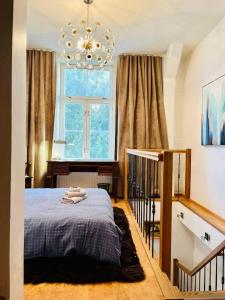 a bedroom with a bed and a chandelier at LOSSI 21/23 in Tartu