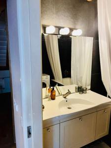 a bathroom with a sink and a mirror at LOSSI 21/23 in Tartu