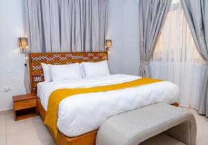 a bedroom with a large bed and a window at Château NaNa Willine in Accra