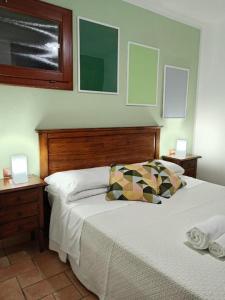 a bedroom with a bed and two nightstands with two lamps at Casa Piredda Icore IUN R7749 in Dorgali +58 photos