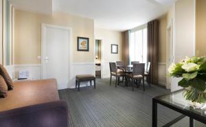 a living room with a table and chairs at Elysees Apartments in Paris