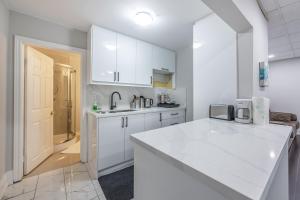 a kitchen with white cabinets and a white counter top at Niagara Nest - Comfy 1BR and 1BA Close to the Falls in Niagara Falls