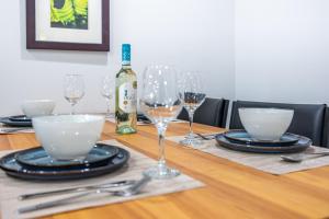 a table with glasses and a bottle of wine at Niagara Nest - Comfy 1BR and 1BA Close to the Falls in Niagara Falls