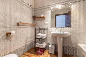 a white bathroom with a sink and a mirror at Padre Aviles in Olías