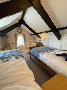 a bedroom with two beds in a attic at Atlantic Cottage Port Isaac 2 bedroom with parking in Port Isaac
