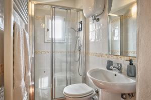 a bathroom with a shower and a toilet and a sink at La Terrazza - Together in Tuscany in Cortona
