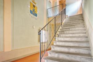 a staircase with metal railings in a building at La Terrazza - Together in Tuscany in Cortona