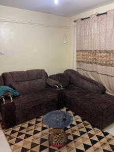 a living room with a couch and a table at Tawakal airbnb in Thika
