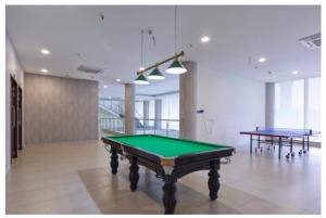 a pool table in a room with two tables at Lavish 3BHK 12th Floor High Rise Apartment for Family in Bangalore