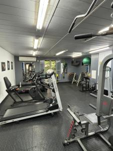 a gym with a treadmill and ellipticals in a room at Apt perto da praia com vaga e serv de arrumadeira in Rio de Janeiro