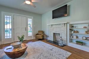 a living room with a fireplace and a tv at Modern Chateau Remodeled Home Close to Downtown in Mobile