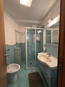 a bathroom with a shower and a sink and a toilet at LA BOMBONIERA in Ischia +5 photos