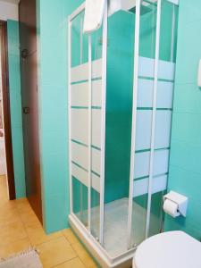 a glass shower in a bathroom with a toilet at LA RIVA appartamento in Perledo +25 photos