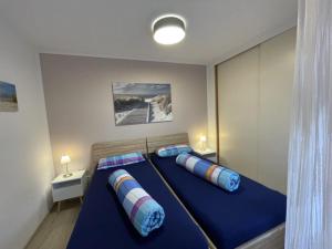 a bedroom with a blue bed with two pillows at Apartment Gerberbachviertel in Weinheim