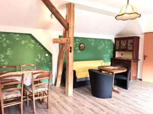 a bedroom with a bed and a table and chairs at Pension Claudia Güldenpfennig in Tangermünde