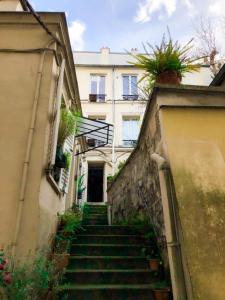 a set of stairs leading up to a building at Au cœur de Montmartre Paris lovers in Paris