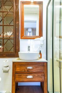 a bathroom with a sink and a glass shower at NİYAMA MARİNA Butik Hotel in Çeşme