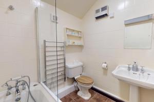 a bathroom with a toilet and a sink and a shower at Sheepfold Cottage Dulverton in Dulverton +23 photos