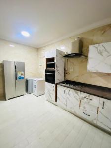 a kitchen with white cabinets and appliances at Eden Haven in Lagos