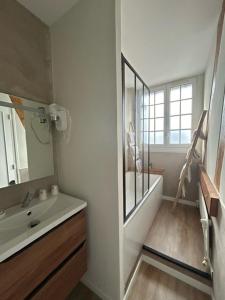 a white bathroom with a sink and a mirror at Hôtel De La Mer - Deauville Blonville - Boutique Hôtel de charme vue Mer ou Campagne - Accès direct plage in Blonville-sur-Mer