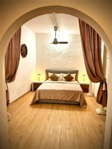 a bedroom with a large bed with an archway at Lovely and cozy central apartment in the best position in Florence