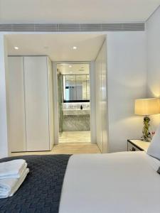 a bedroom with a large white bed and a window at Luxury Hidden Gem 2BDR APT In Mayfair in London