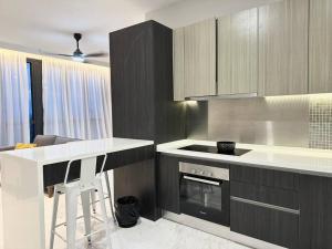 a kitchen with a counter and a stove top oven at Designer Studio Sky 88 JB Town in Johor Bahru