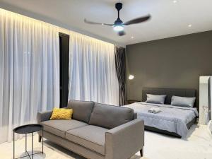 a living room with a couch and a bed at Designer Studio Sky 88 JB Town in Johor Bahru