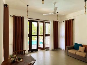 a living room with a couch and a table at Linton Villa in Kalutara