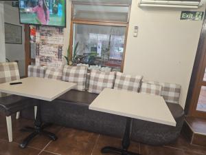 a restaurant with two tables and a couch at Priyateli - Friends in Veliko Tŭrnovo