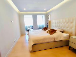 a bedroom with a large bed and a large window at Incroyables appartements dans une résidence de haut standing in Cannes
