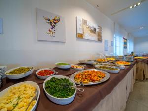 a buffet with many plates of food on a table at Hotel Eden Park Cilento in Policastro Bussentino