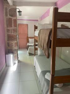 a room with several bunk beds in a house at Multiverso Hostel in Lençóis