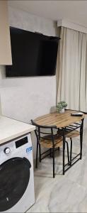 a living room with a table and a microwave at нов модерен ! Studio Apartment Dreams 2! in Sliven