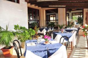 a group of tables with blue and white table cloth at MAESTRALE B&B in Arbus