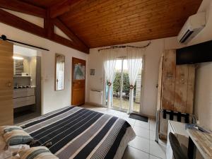 a bedroom with a bed and a large window at Villa Herbert, Chambres d'Hôtes et Gîte in Andernos-les-Bains