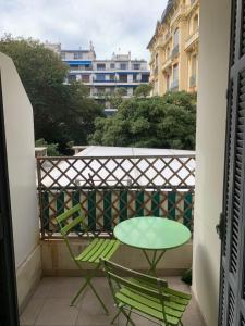 a table and two chairs on a balcony at Chez Chebil in rue Halevy - near the sea in Nice