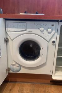 a washing machine in a cabinet in a kitchen at Chez Chebil in rue Halevy - near the sea in Nice