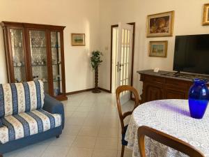a living room with a couch and a table at Casa Rina in Livorno