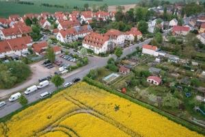 an aerial view of a town with a field of yellow flowers at Residenz Hotel Leipzig in Leipzig