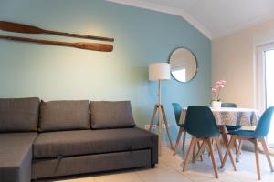 a living room with a couch and a table at Apartments Baleal: Balconies and Pool in Ferrel