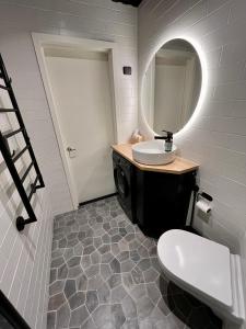 a bathroom with a sink and a mirror at Hogland Apartments - 3 in Kotka