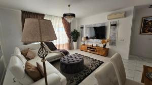 a living room with a white couch and a table at Coastal Dream Villa in San Miguel de Abona