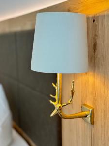 a lamp with a antler on a wall at Hotel Tannenhof in Bad Harzburg