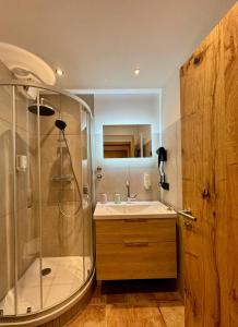 a bathroom with a shower and a sink at Hotel Tannenhof in Bad Harzburg