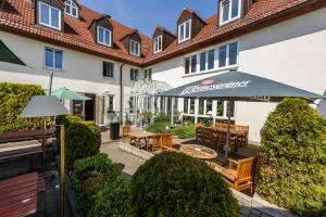 a hotel with a patio with tables and benches at Residenz Hotel Leipzig in Leipzig